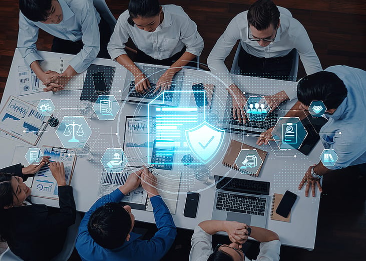 A IT team collaborating on a digital security strategy in a modern office.
