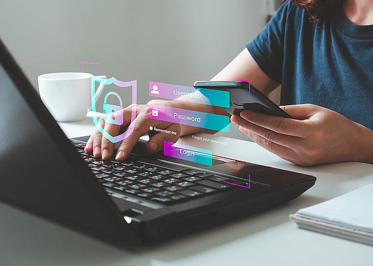 A person protecting personal data and virtual interfaces online through multi-factor verification and internet network security technology on a laptop.