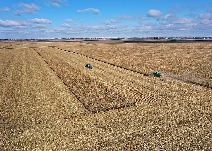 An aerial view showing workers from Pinicon Farm harvesting corn near McIntire, Iowa, USA.