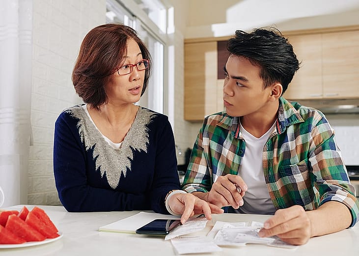A mother advising her young son on school and expenses.
