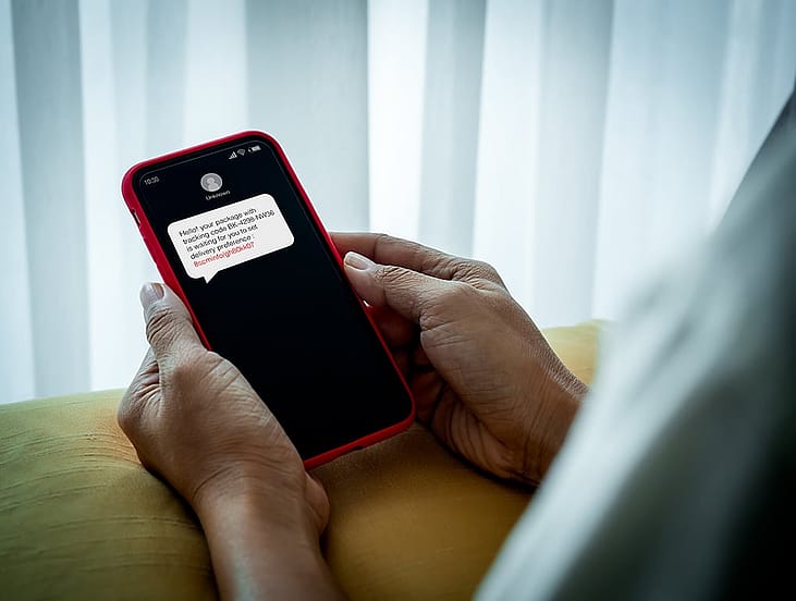 A person receiving a suspicious text message.
