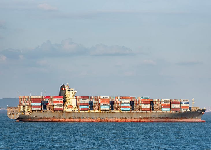 A HERTA ship fully loaded with shipping containers anchored near the Chinese coast at the East China Sea.