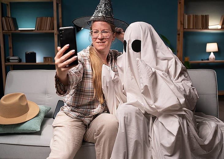 Two friends taking a selfie in their Halloween costumes.