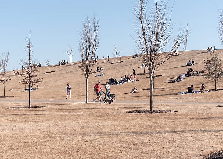 People enjoying time on a sunny winter afternoon at Scissortail Park in Oklahoma City, Oklahoma, USA.