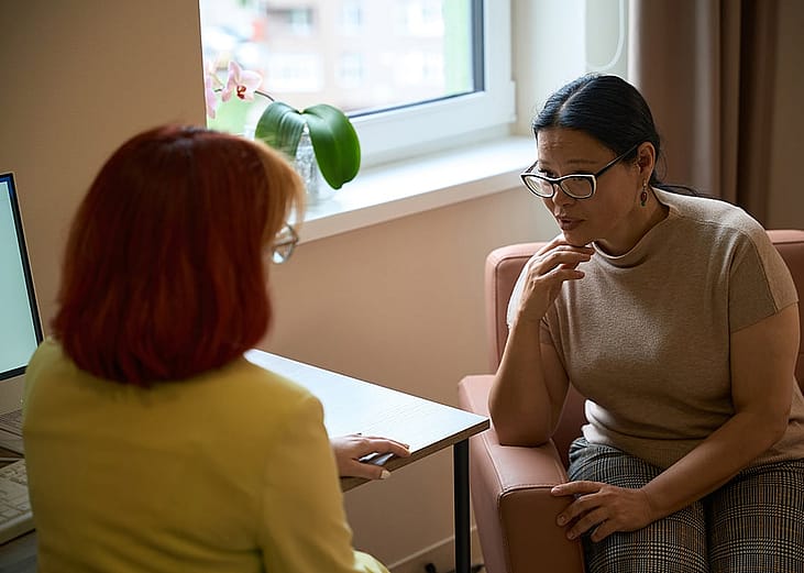 Two women having a discussion in an office.