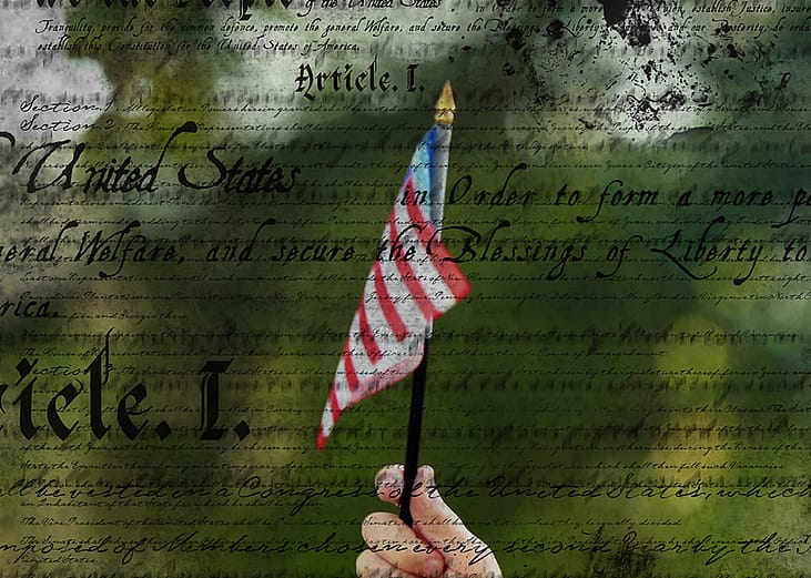 Hand holding up an American flag with a text overlay of the US Constitution.