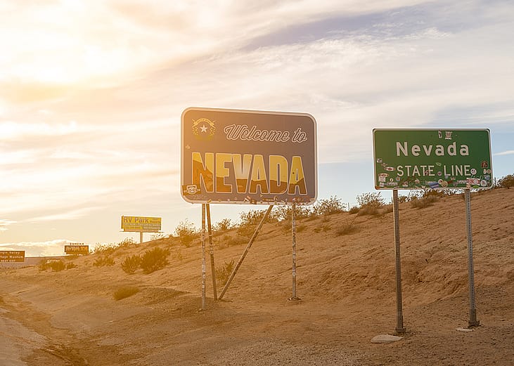 A 'Welcome to Nevada' signage during sunset.