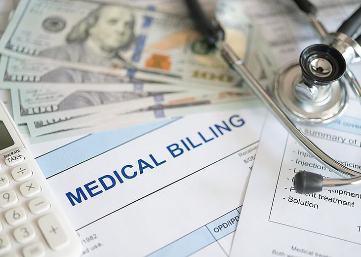 Medical billing document with banknotes and a stethoscope.