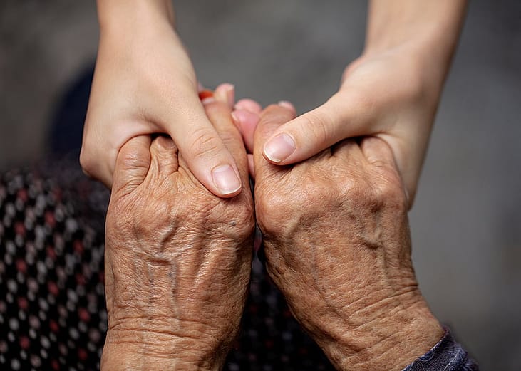 Hands of an old and young persons as a concept of assisting older generation.