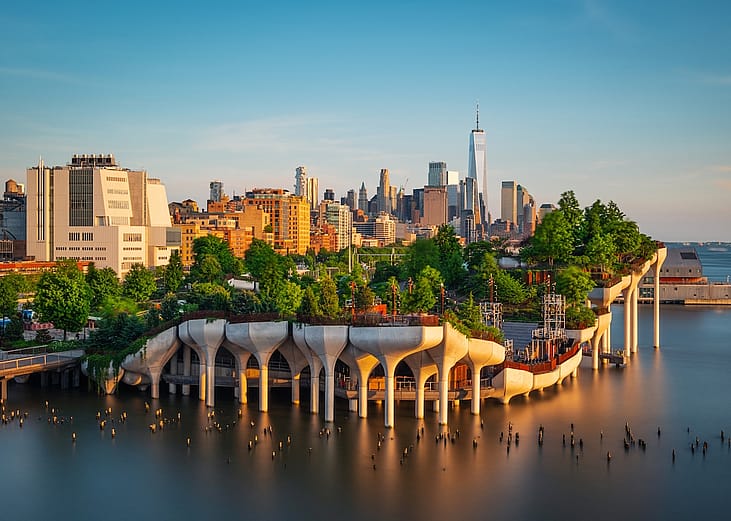 Little Island over the Hudson River in Chelsea, New York at dusk, with the lower Manhattan skyline in the backdrop.