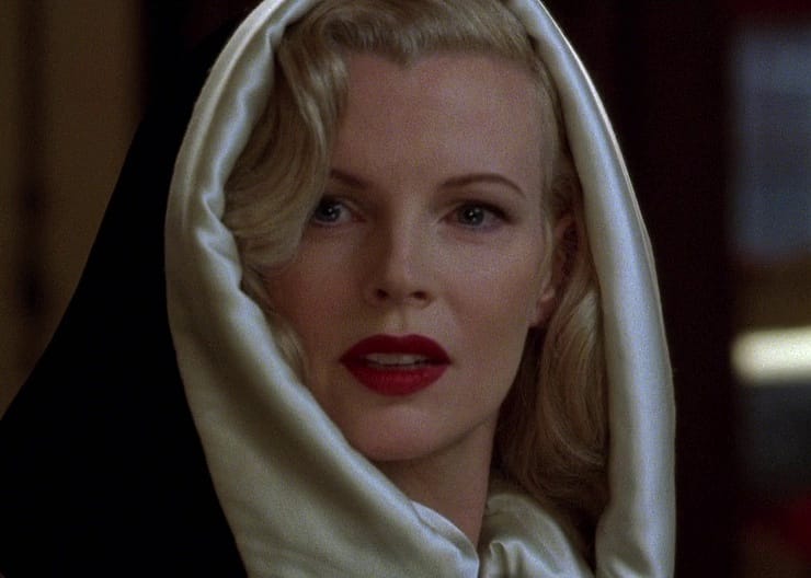 Kim Basinger in a black and white silk hood.