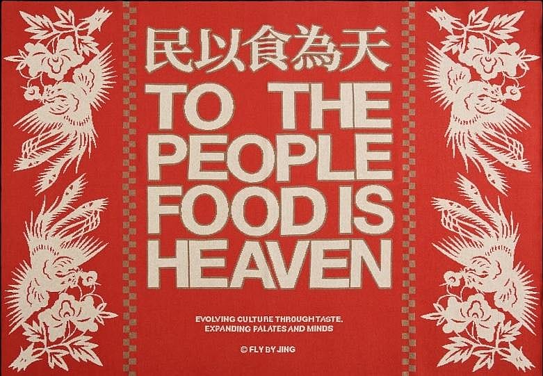 A red Fly By Jing blanket with “To the people food is heaven” in white text. 