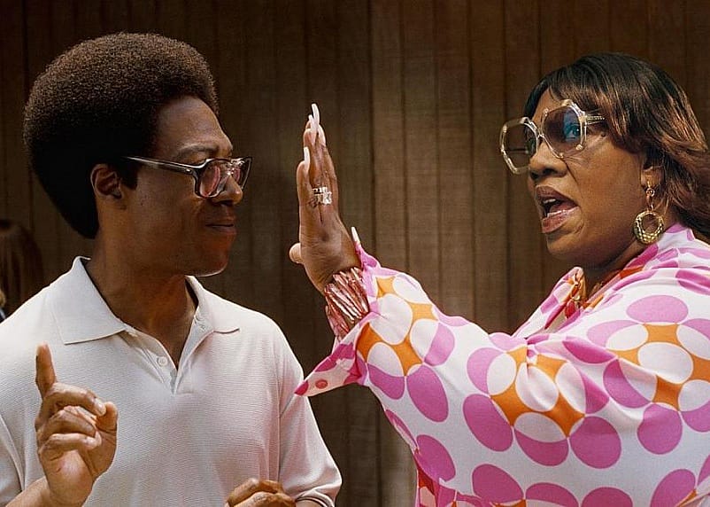 Eddie Murphy getting a hand to the face by an older woman, also played by Eddie Murphy.