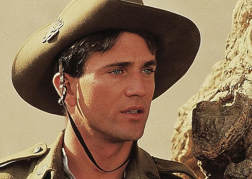 Mel Gibson in a military hat and jacket.