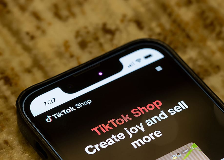 Webpage of TikTok Shop is seen on its corporate website on an iPhone. — Tada Images // Shutterstock