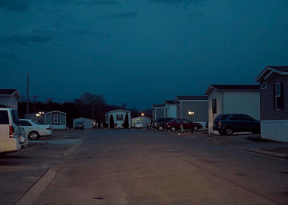 Dusk falls on cars parked next to mobile homes in a mobile park owned by a private equity firm in Smyrna, Tennessee. — Stacy Kranitz for The Washington Post via Getty Images