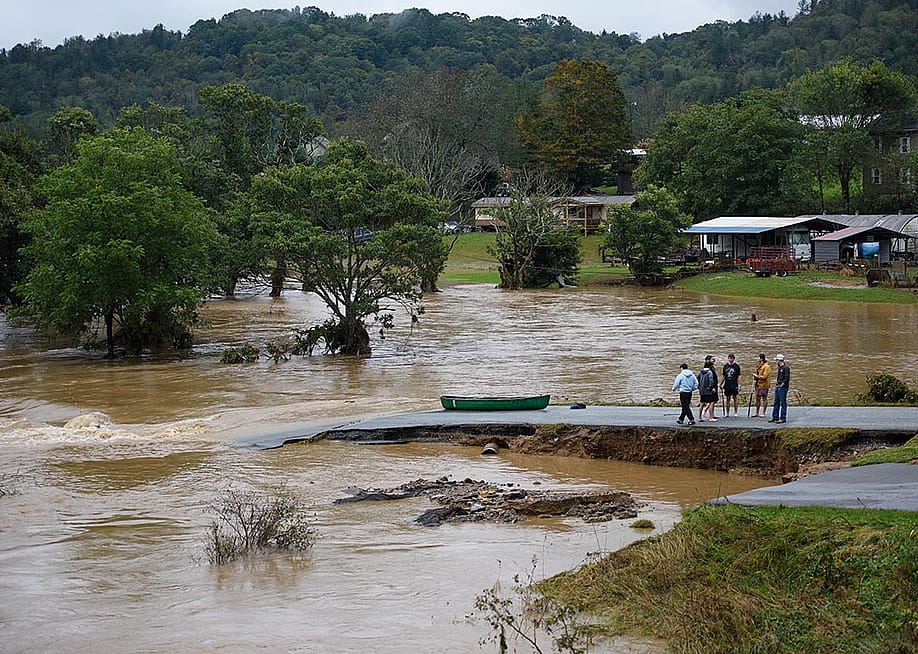 Residents that canoed the flooded South Fork New River talk at a washed out road on September 27, 2024 in Boone, North Carolina — Melissa Sue Gerrits // Getty Images