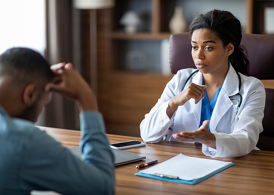 Black female doctor having a conversation with her patient. — Prostock-studio // Shutterstock
