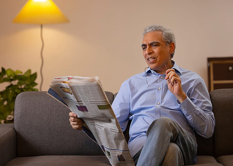 Senior man reading a newspaper in confusion. — India Picture // Shutterstock