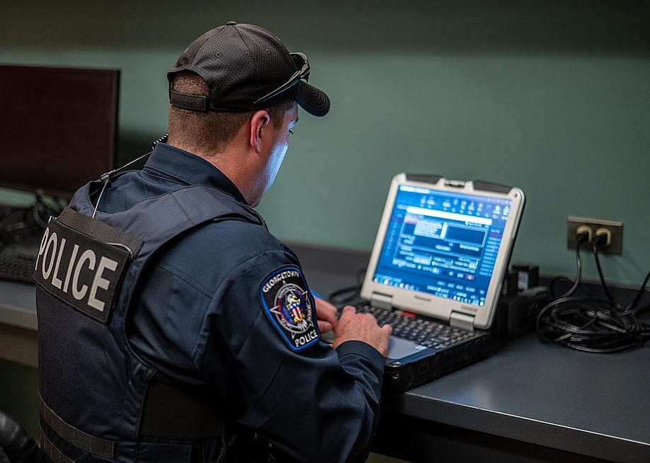 A police officer uses his computer in Georgetown, Texas, in 2023. — Sergio Flores for The Washington Post via Getty Images