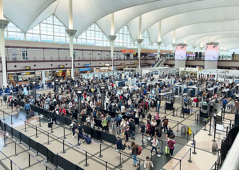 A high-angle view of a crowded TSA security checkpoint at Denver International Airport (DIA). — Arina P Habich // Shutterstock