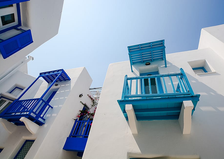 Daytime view of the exterior of Santorini, Greece-style buildings. — Tirachard Kumtanom // Shutterstock