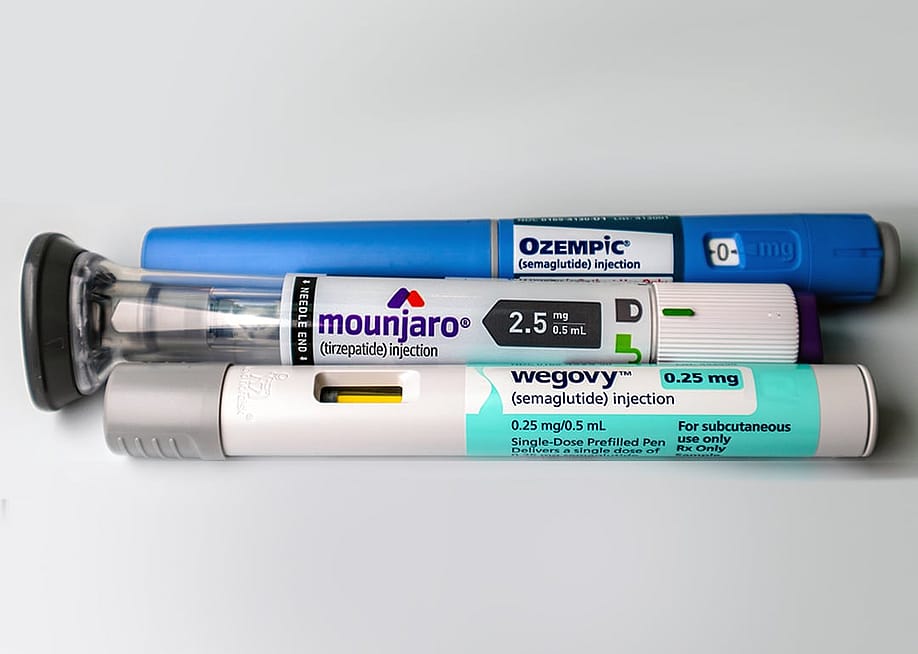 Mounjaro, Ozempic and Wegovy pens on a white background. — KK Stock // Shutterstock