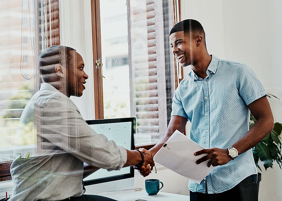 Two businessmen shaking hands after a meeting. — PeopleImages.com - Yuri A // Shutterstock