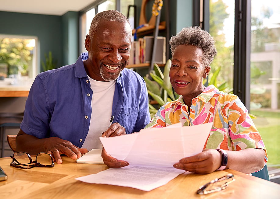 Senior couple at home reviewing finances. — Monkey Business Images // Shutterstock
