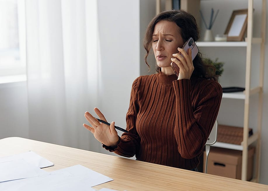Woman worryingly talking on the phone. — ShotPrime Studio // Shutterstock