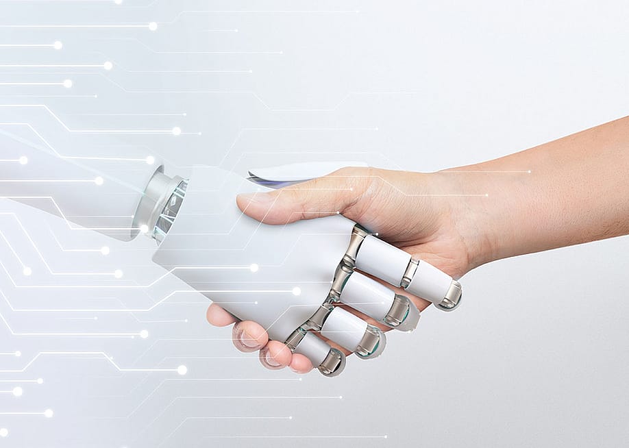 Human hand shaking robot hand, symbolizing human-robot collaboration and technology. — Rawpixel.com // Shutterstock