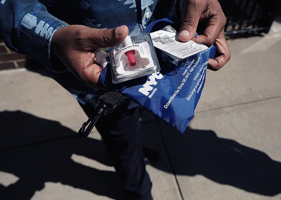 A Services for the UnderServed (S:US) worker holds a naloxone overdose kit. — Spencer Platt // Getty Images