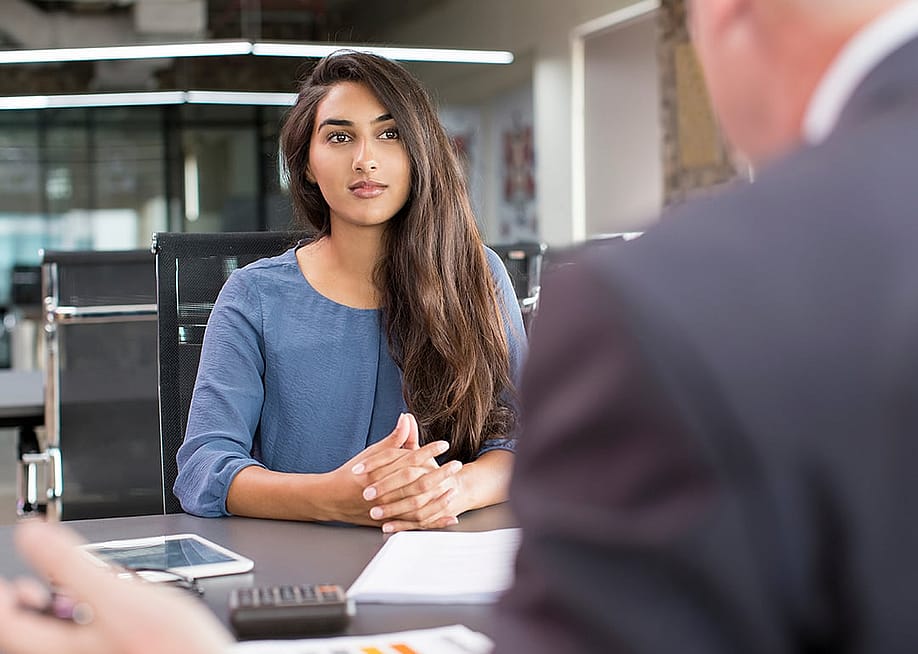 Young female professional meeting with a hiring manager during a job interview. — Mangostar // Shutterstock
