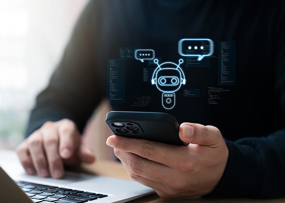 Businessman using smartphone to connect to an AI chatbot. — Thapana_Studio // Shutterstock