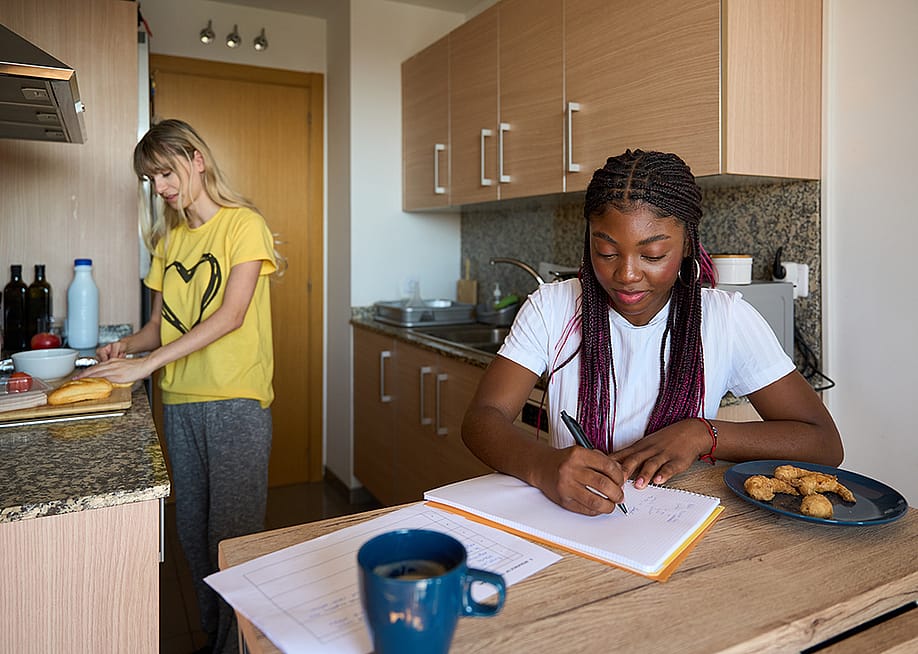 Two young adult women who are roommates in a small apartment. — alvarog1970 // Shutterstock