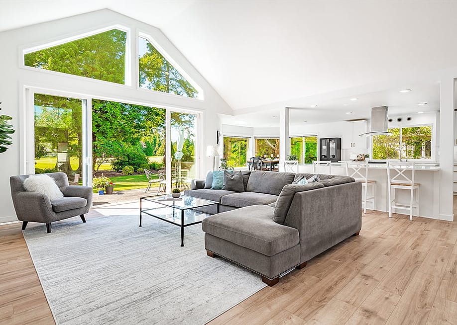 A large open living room with multiple expansive windows. — Sheila Say // Shutterstock