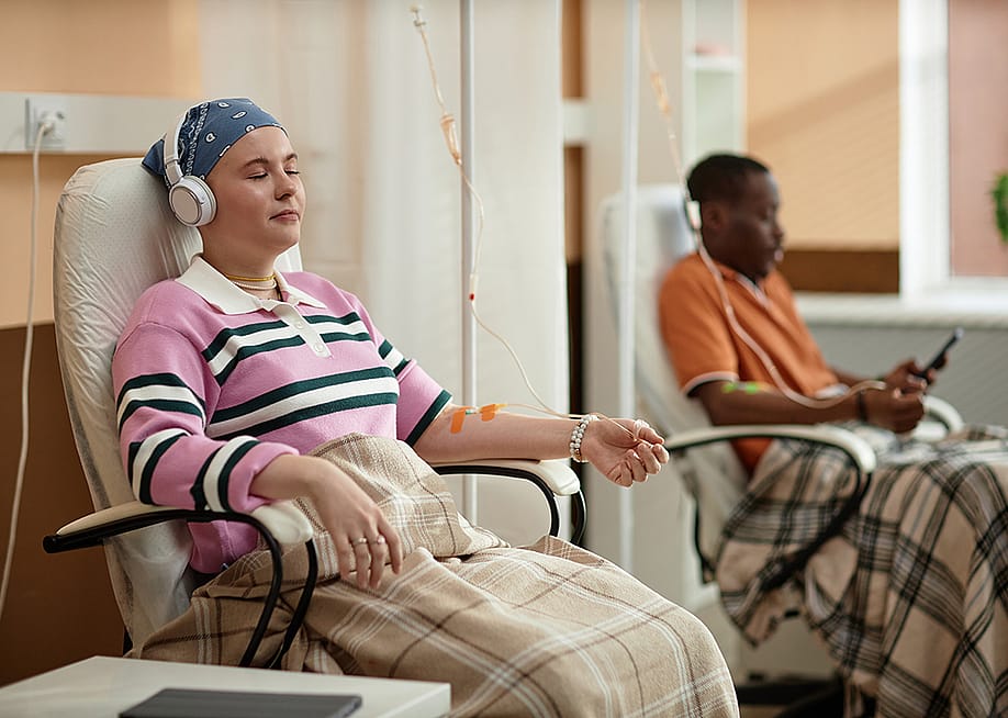 Chemotherapy patients listening to music during a treatment session. — SeventyFour // Shutterstock