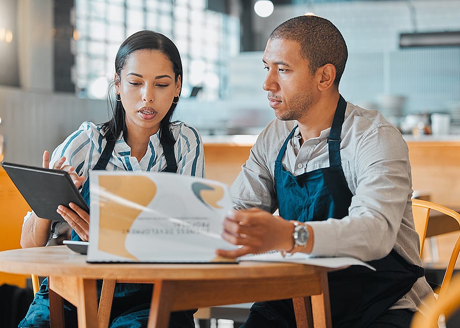 Cafe small business owners planning budget and other business concerns. — PeopleImages.com - Yuri A // Shutterstock