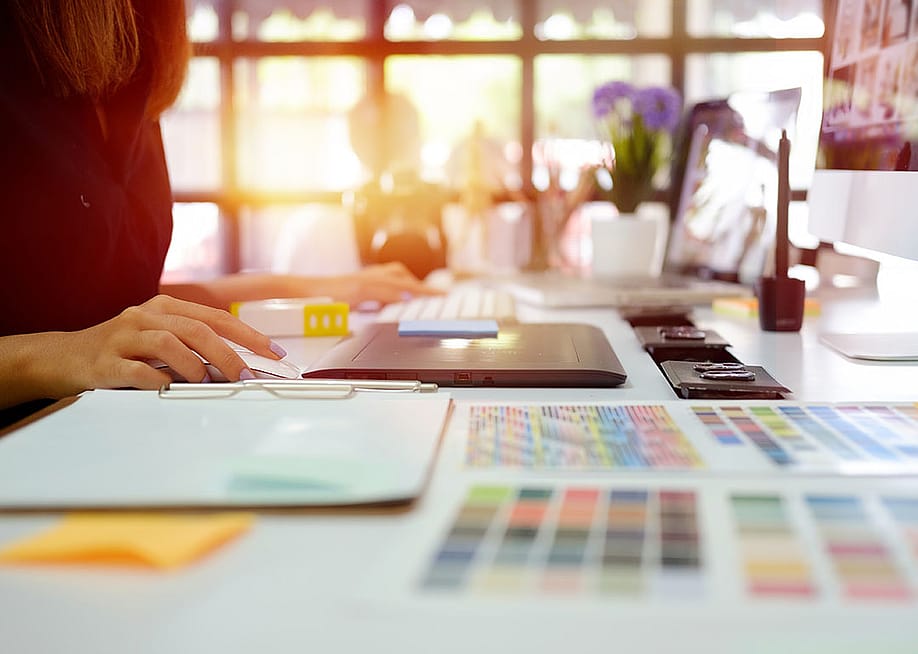 A young graphic designer at work in office. — BongkarnGraphic // Shutterstock