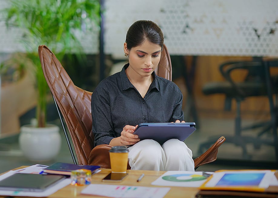Young businesswoman in workplace using a tablet to browse information online. — Raushan_films // Shutterstock
