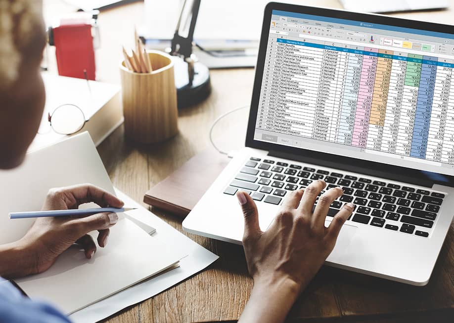 Young female entrepreneur looking at a spreadsheet report. — Rawpixel.com // Shutterstock