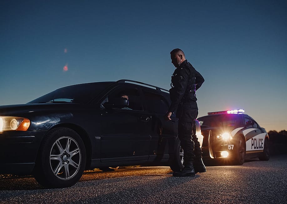 Police pulling a driver on the side to inspect driving behavior. — Gorodenkoff // Shutterstock