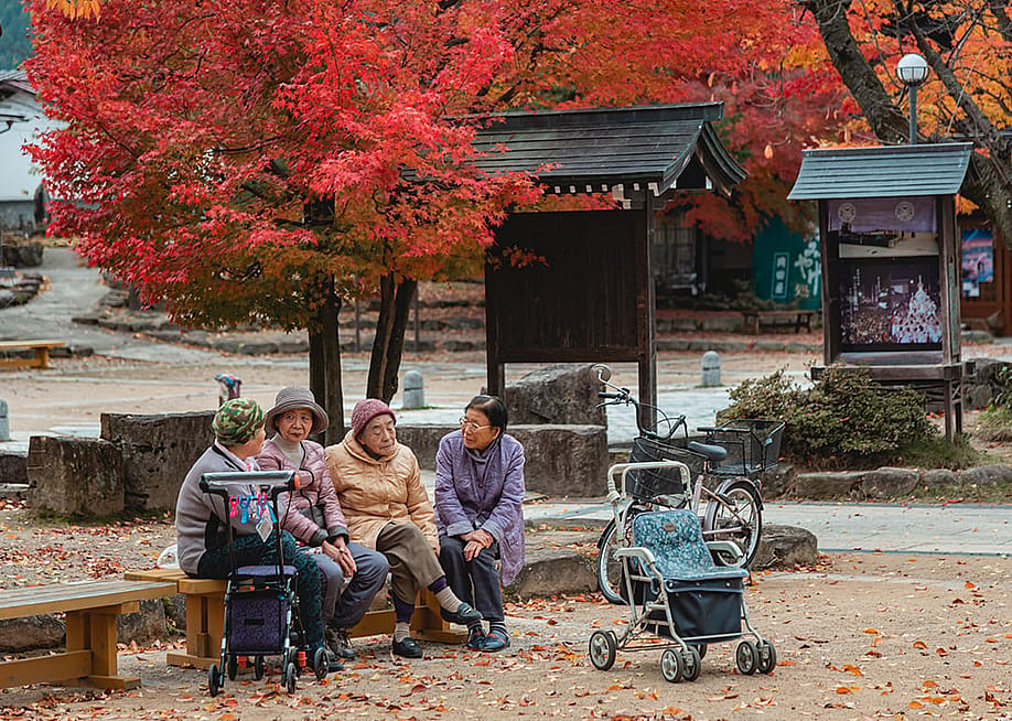 Four elderly women chatting in a garden in Takayama, Japan. — Pasakorn Hansetagan // Shutterstock