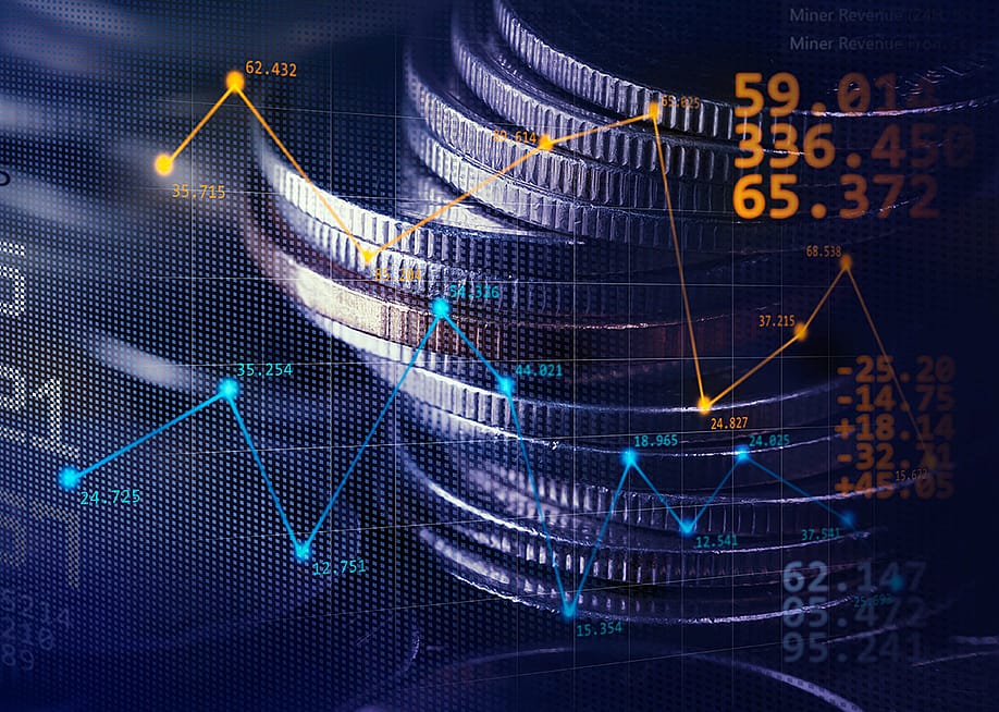 Stack of coins illustrated with stock exchange graphics. — CHOKCHAI POOMICHAIYA // Shutterstock
