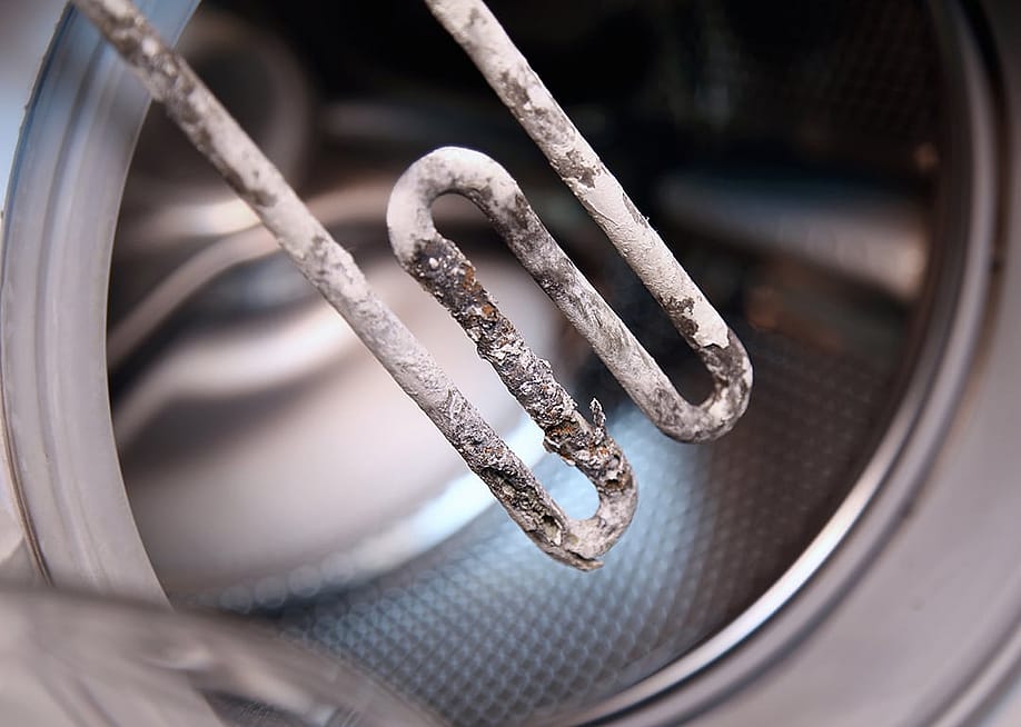 Electric heater from washing machine aged by hard water. — Vladimir Mucibabic // Shutterstock