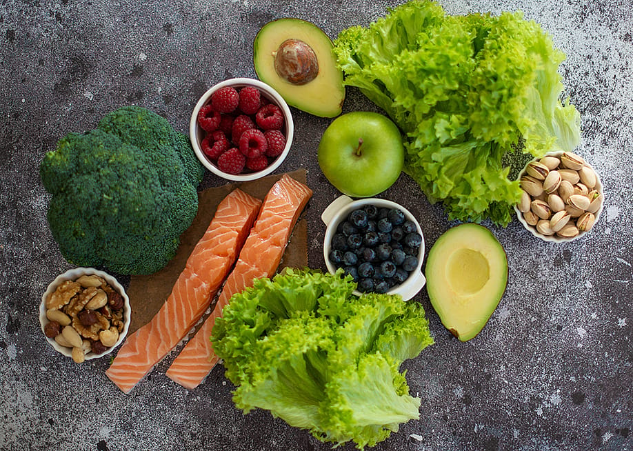 A selection of healthy foods such as salmon fish, superfoods, nuts, fruits, berries and leafy vegetables. — Margarita0192 // Shutterstock