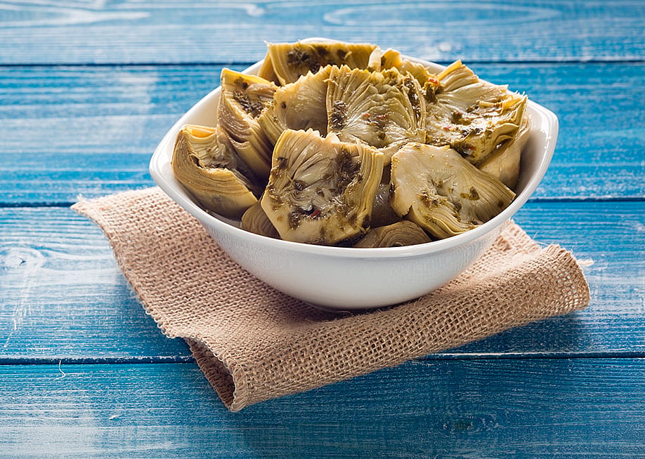 A bowl of grilled artichokes in oil. — Angelo Chiariello // Shutterstock
