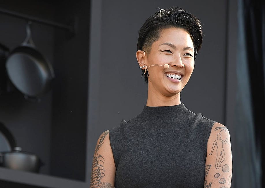Chef Kristen Kish, wearing a black sleeveless mock turtleneck and mic headset speaks at a culinary demonstration during the 2025 Bottle Rock Napa Valley festival. — Tim Mosenfelder // FilmMagic