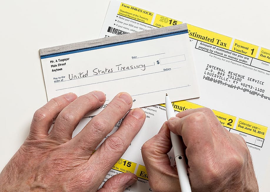 Taxpayer writing a check to the U.S. treasury. — Steve Heap // Shutterstock