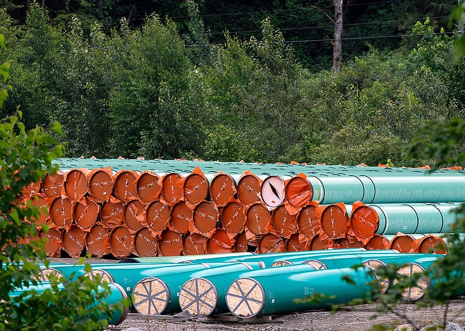 Pieces of the Trans Mountain Pipeline project sit in a storage lot outside of Hope, British Columbia, Canada. — COLE BURSTON // AFP via Getty Images